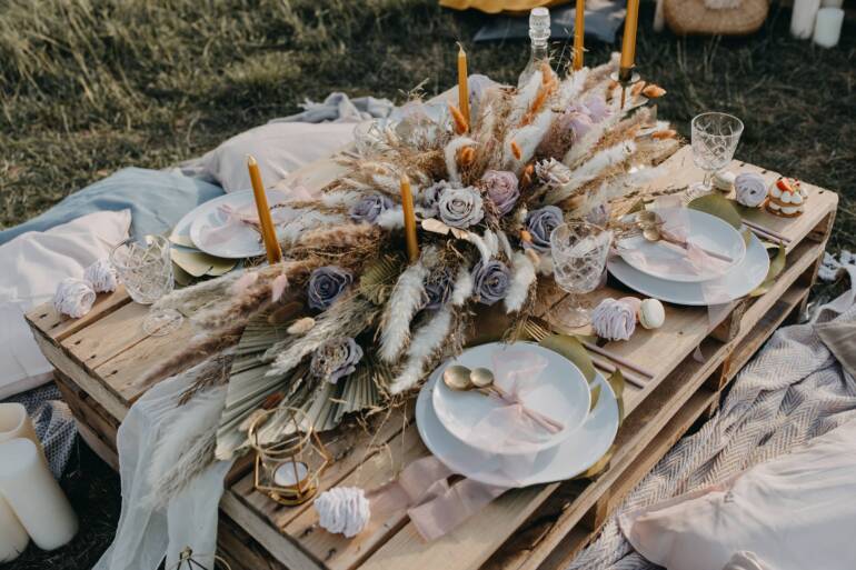 Charming picnic infused with boho and regal vibes, adorned in soft shades of rose gold and beige, creating a warm and inviting atmosphere.