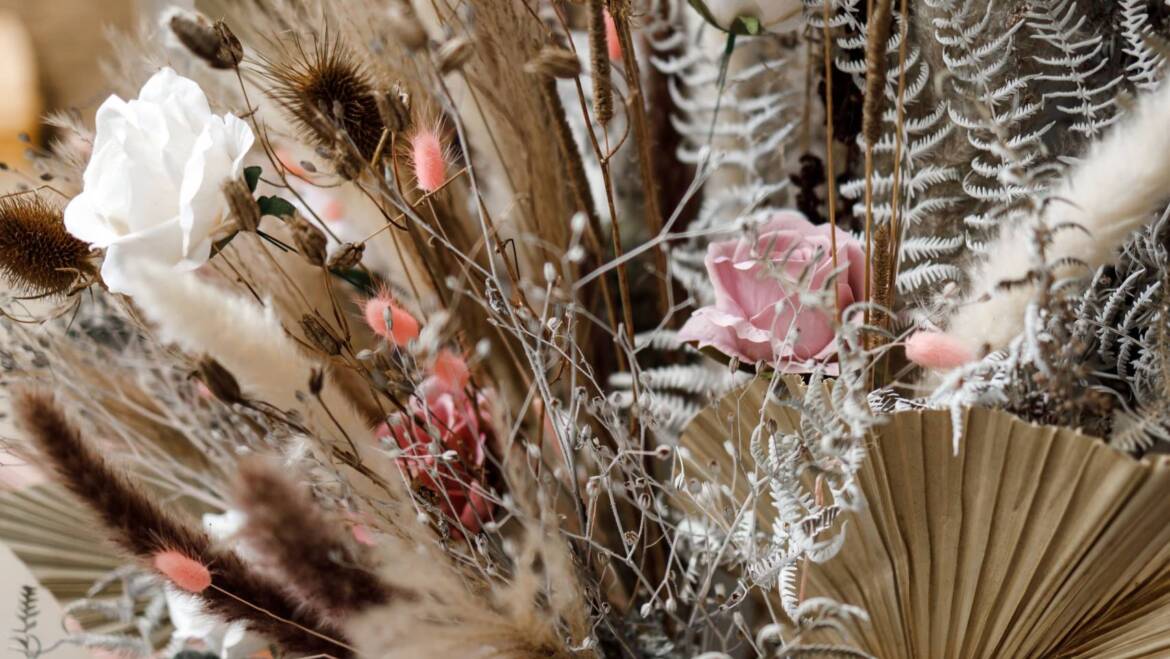 A selection of dried plants and preserved roses, artfully arranged for a grand opening display event, elegance, and charm for a sophisticated ambiance.