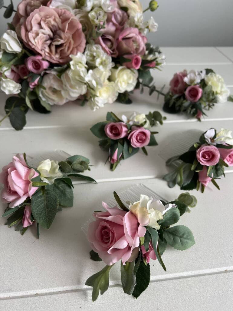 Wedding accessories from artificial flowers in a delightful mix of pink and white.