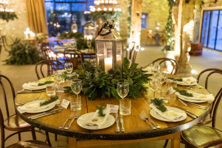 Lush evergreens and delicate thistle-  a romantic winter wedding, with sparkling white baubles, gently kissed by the warm glow of candles.