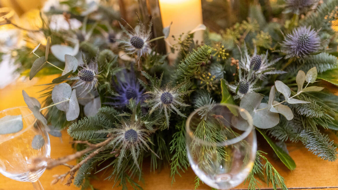 Lush evergreens and delicate thistle-  a romantic winter wedding, with sparkling white baubles, gently kissed by the warm glow of candles.
