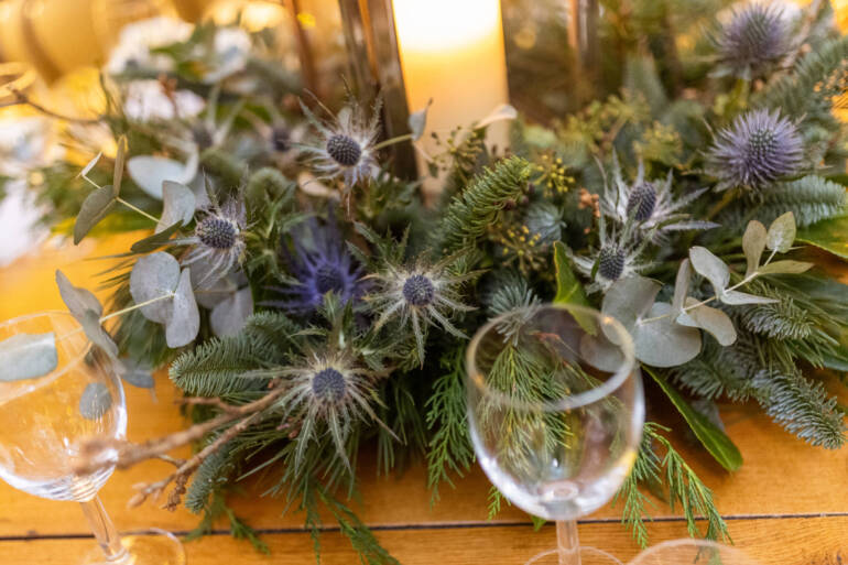Lush evergreens and delicate thistle-  a romantic winter wedding, with sparkling white baubles, gently kissed by the warm glow of candles.