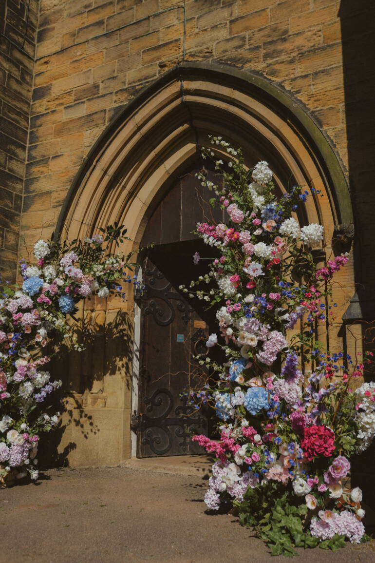 Fairytale-inspired ceremony with lush blooms and flowing greenery, creating a magical, romantic setting for “I do”