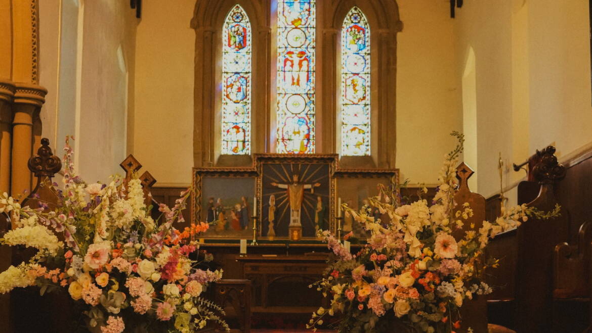 Fairytale-inspired ceremony with lush blooms and flowing greenery, creating a magical, romantic setting for “I do”