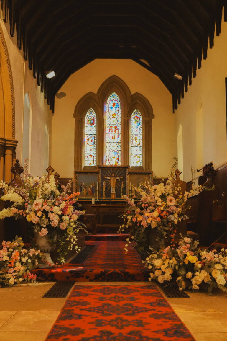 Fairytale-inspired ceremony with lush blooms and flowing greenery, creating a magical, romantic setting for “I do”