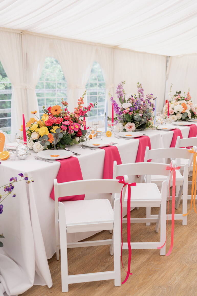 Bright summer flowers for a  garden-style wedding, bursting with vivid colors and lush greenery, creating a cheerful, lively, and sunlit floral atmosphere