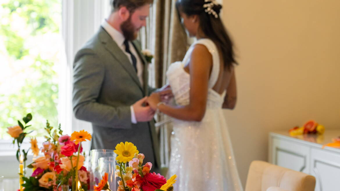 Bold, colourful  table flower arrangements, paired with fresh, juicy citrus fruits- a vibrant, lively, and refreshingly playful table setting.