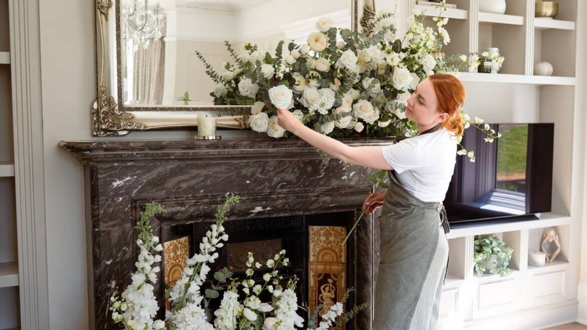 Fire place arrangement in soft ivory blooms, creating an elegant, refined, and timeless atmosphere with understated sophistication.