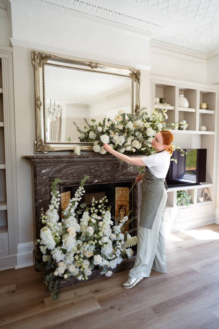 Fire place arrangement in soft ivory blooms, creating an elegant, refined, and timeless atmosphere with understated sophistication.