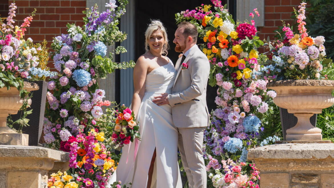 Cascading flowers in a bold, colorful mix flow through the wedding, intertwined with fresh, juicy citrus fruits – a vibrant, lively, and refreshing celebration