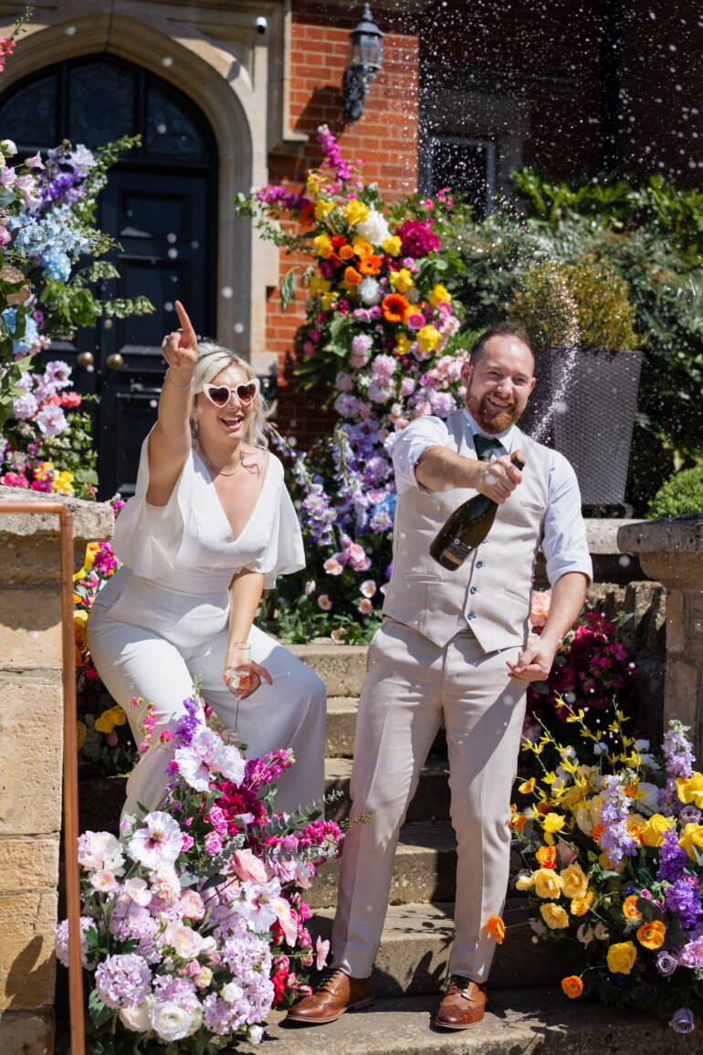 Cascading flowers in a bold, colorful mix flow through the wedding, intertwined with fresh, juicy citrus fruits – a vibrant, lively, and refreshing celebration