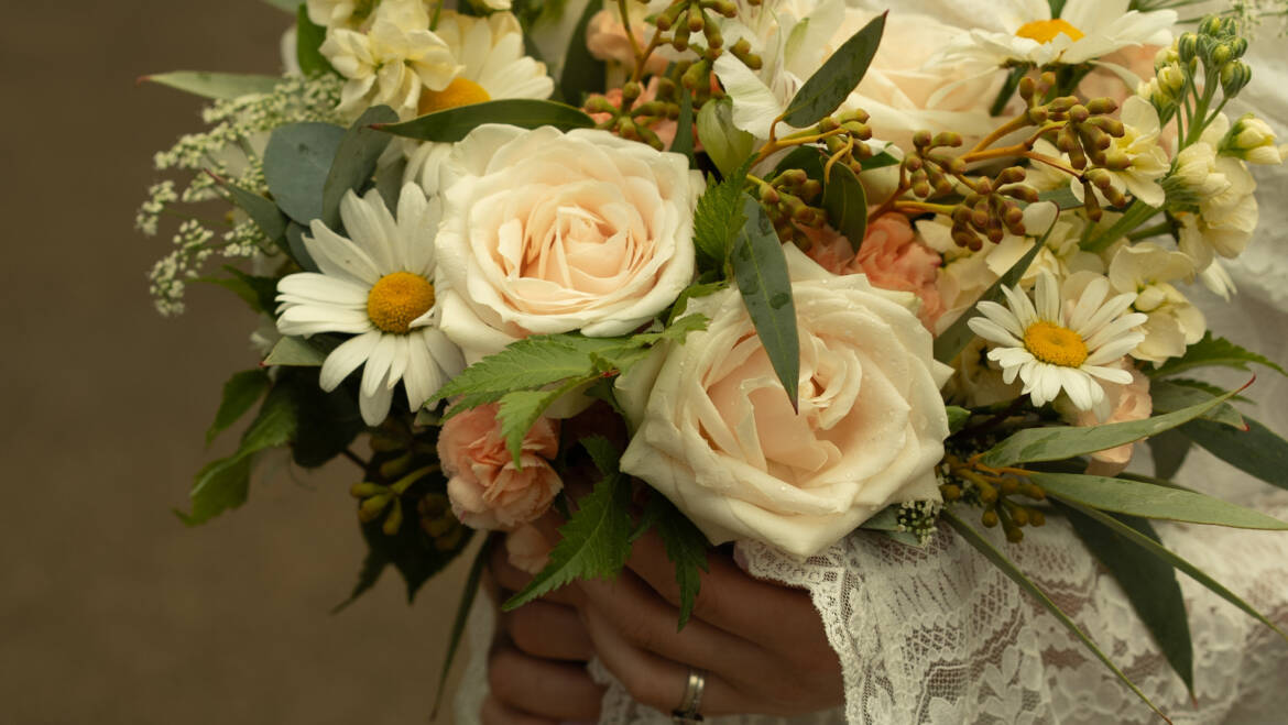 Fine roses with whimsical wild daisies and soft eucalyptus-  a romantic, fresh, and effortlessly natural bridal bouquet