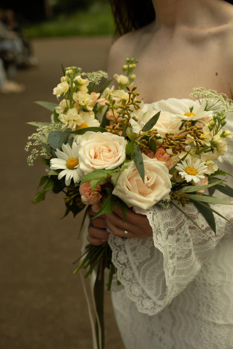 Fine roses with whimsical wild daisies and soft eucalyptus-  a romantic, fresh, and effortlessly natural bridal bouquet
