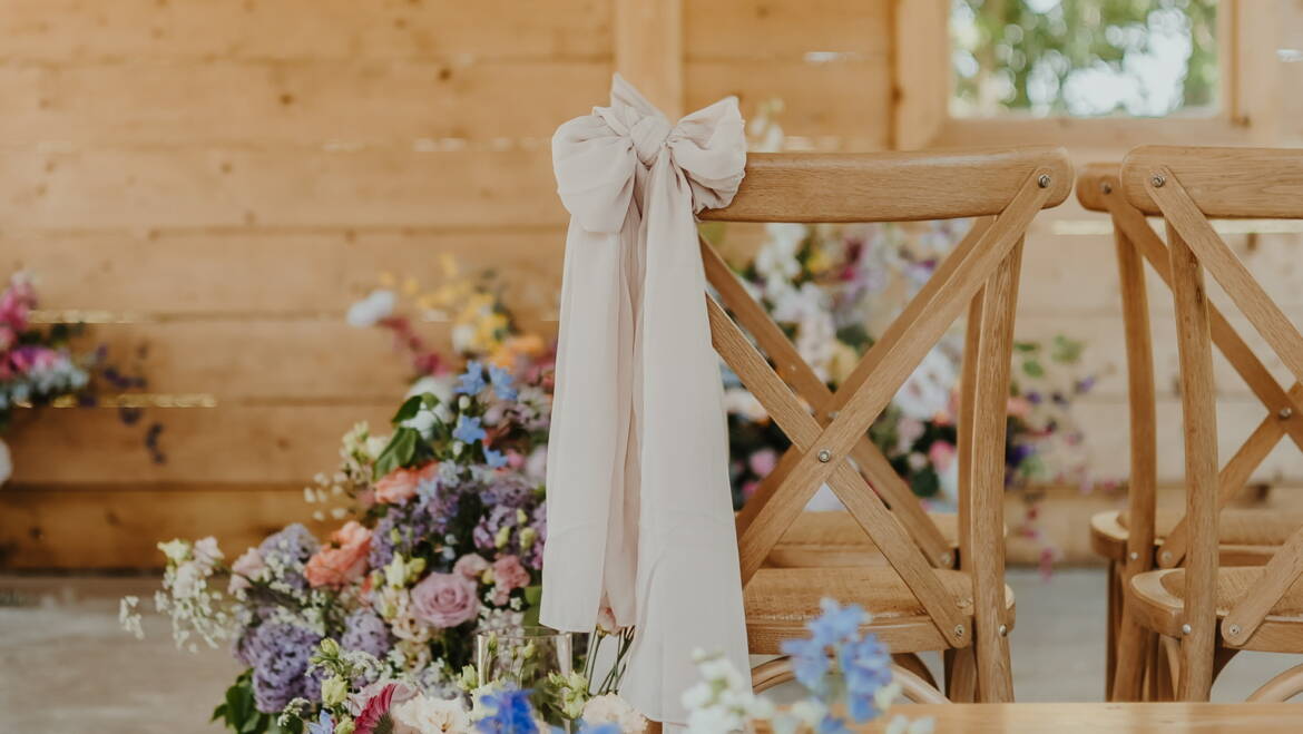 Ceremony space  filled with soft pastel blooms and gentle greenery, creating a serene, romantic, and airy floral setting